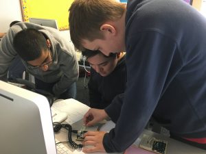 photo of students fixing circuit board